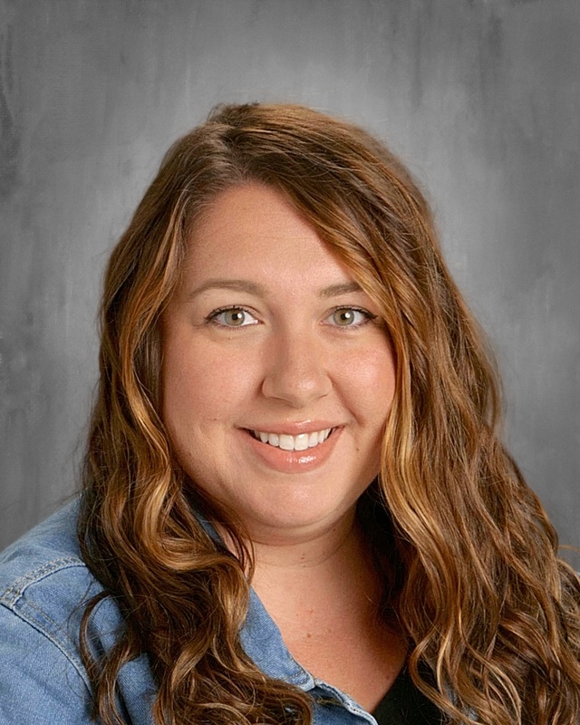 photo of woman with long brown hair wearing denim shirt