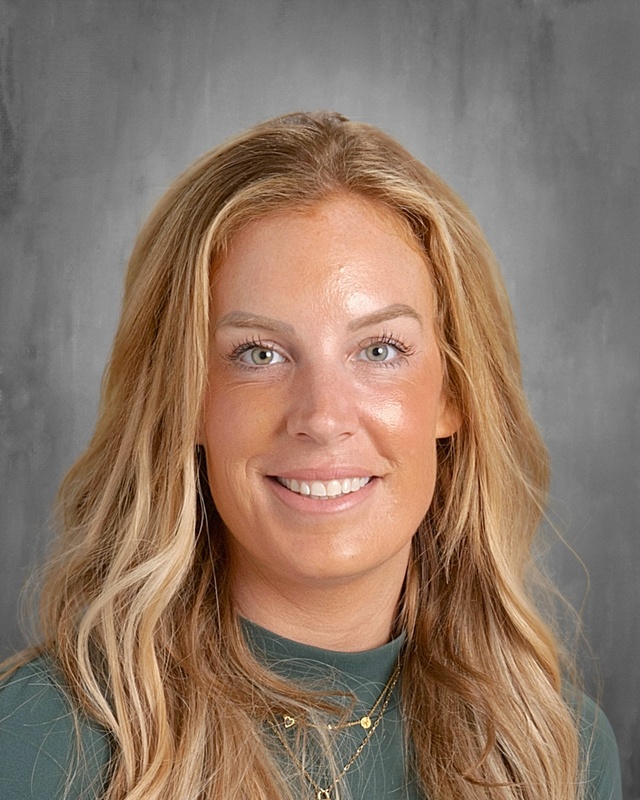 photo of woman with long blonde hair wearing green shirt
