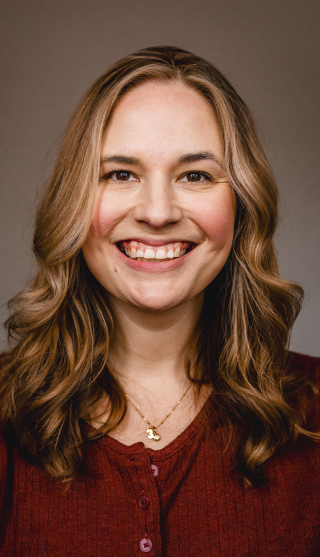 woman with long brownish blonde hair wearing maroon shirt