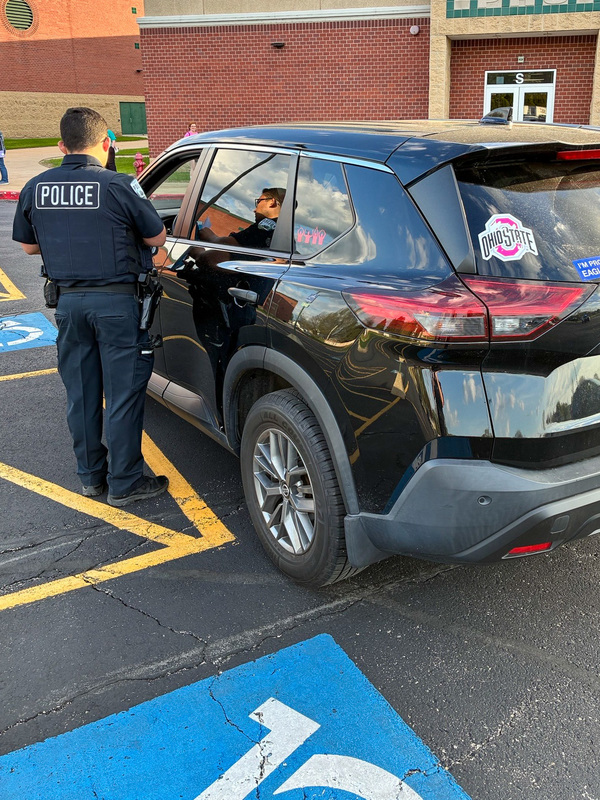 police officer talks to driver in SUV