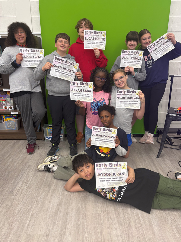 group of students holding small signs