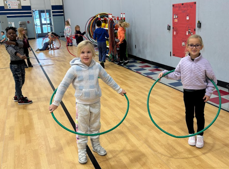 Students playing with hulahoops