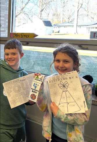 4th graders posing with fourth grade day packets