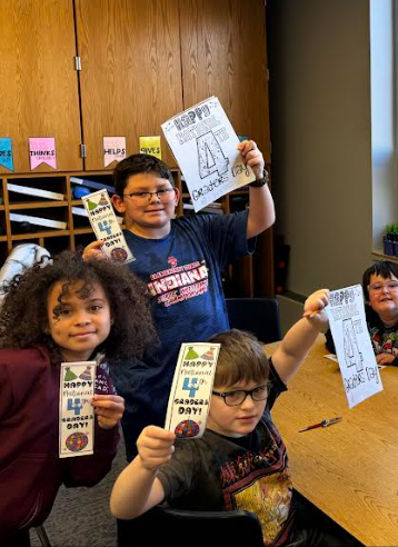 4th graders posing with fourth grade day packets