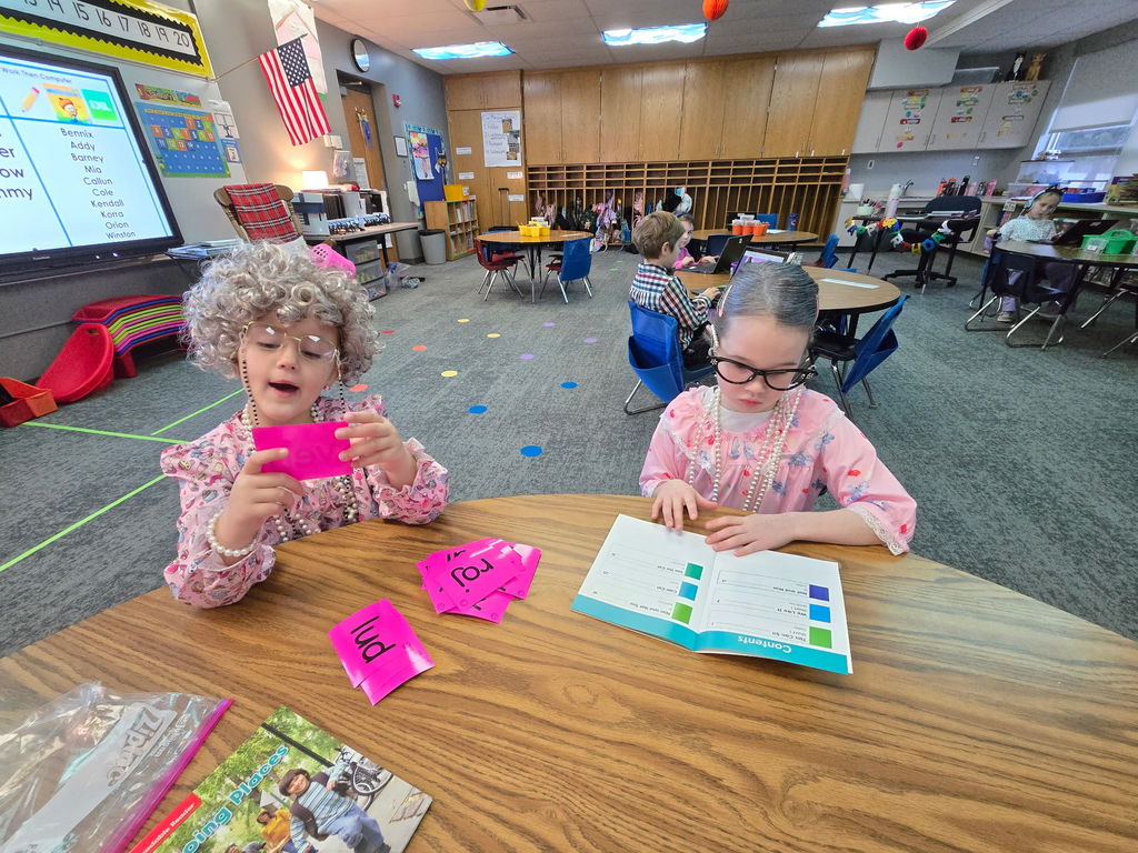 kindergarten students in reading center dressed as 100 year olds