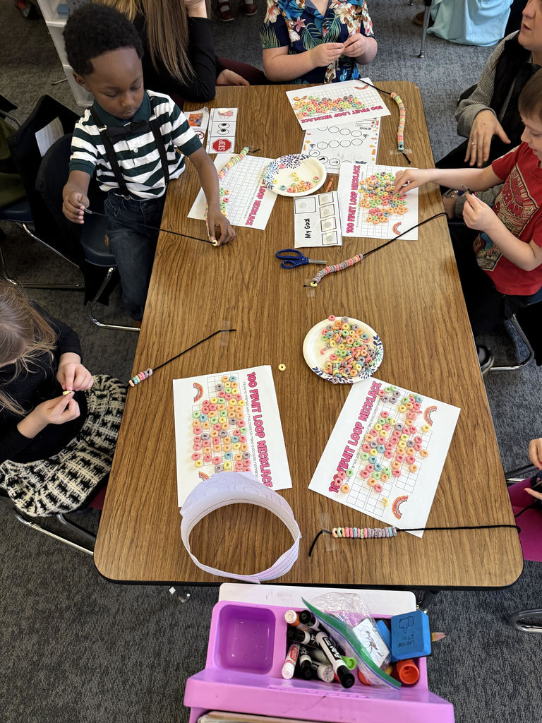 kindergarten  students counting 100 pieces of cereal for 100 day