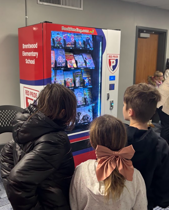 Kids looking at book vending machine