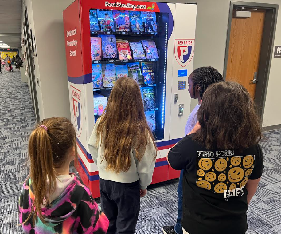 Students looking for a book rom the book vending machine