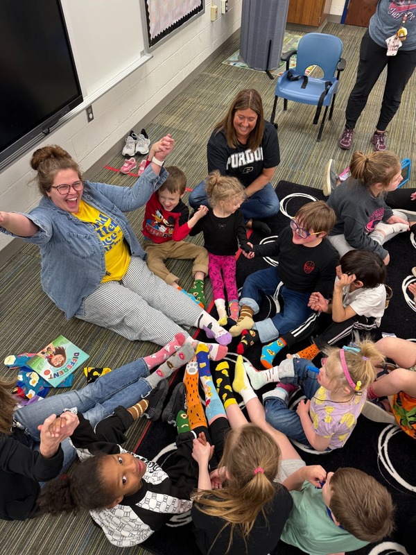 Teacher with students and crazy socks