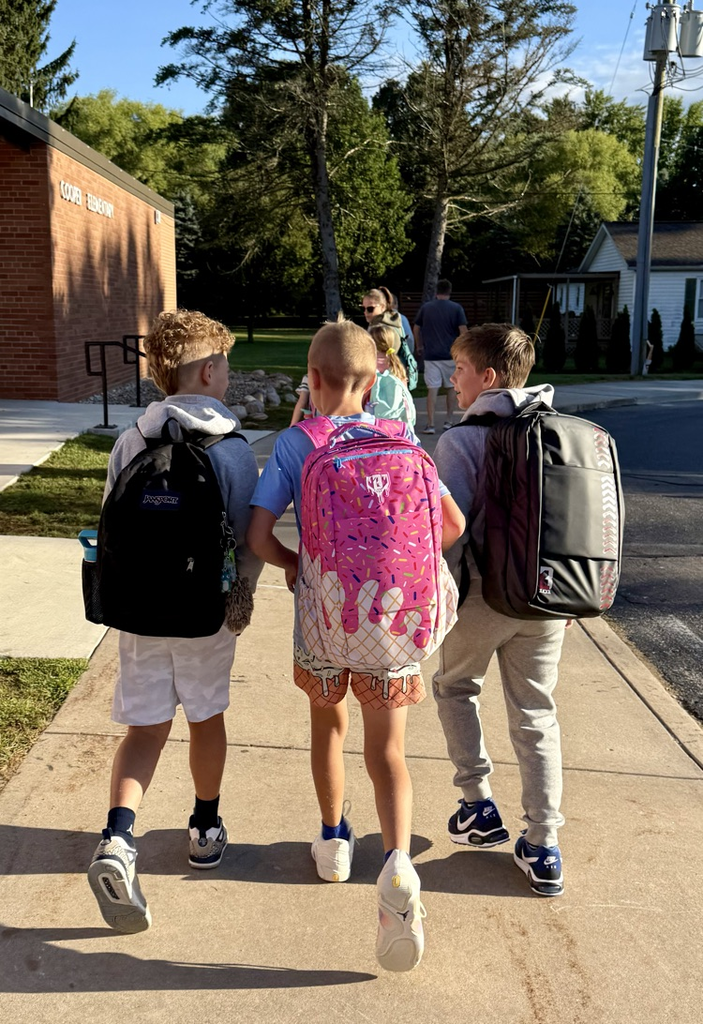 picture of three students walking into first day of school
