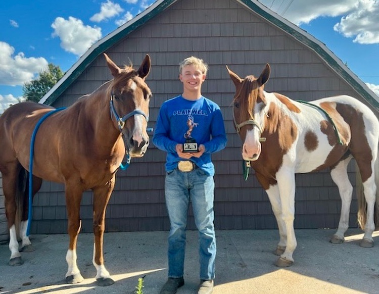 picture of phs senior with his horses at a competition 