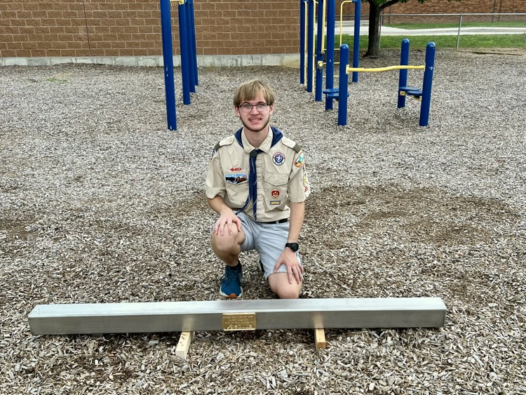picture of phs student with a balance beam he added to the playground at Starr for a project 