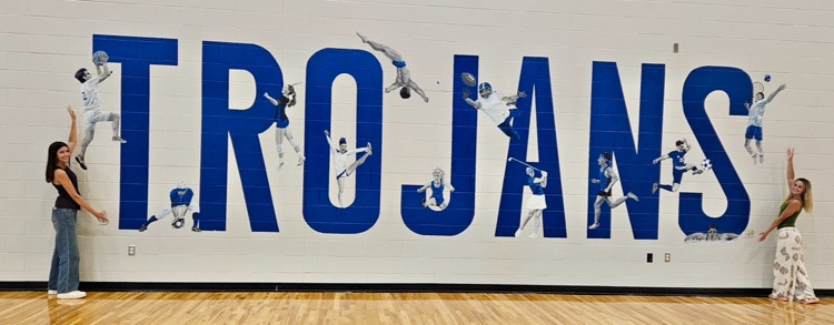 picture of students standing in front of mural they painted at the field house 