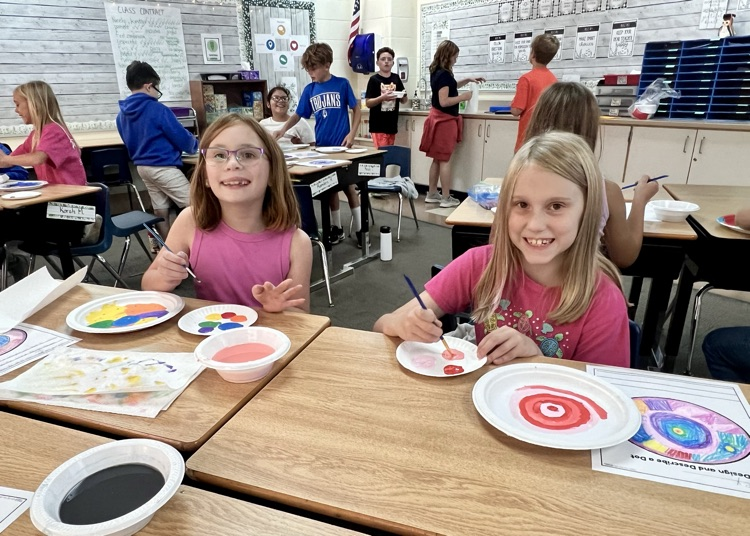 picture of two students doing artwork 