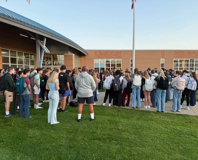 picture of group of students gathered around flagpole at PHS