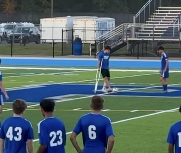 picture of soccer playing kicking the ball