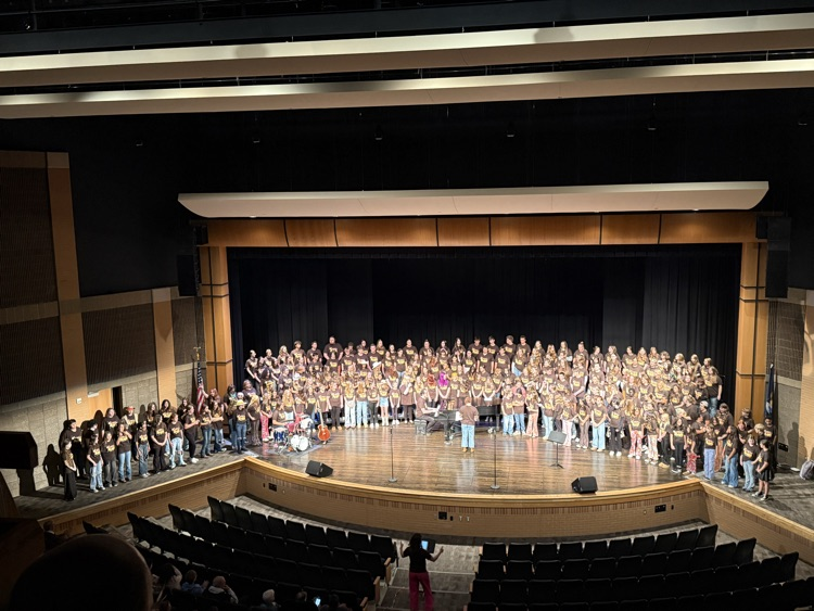 picture of middle and high school choirs performing together