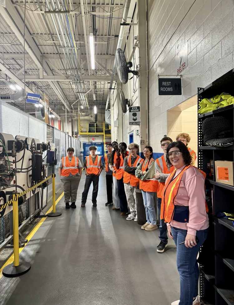 picture of students and teacher touring a manufacturing facility