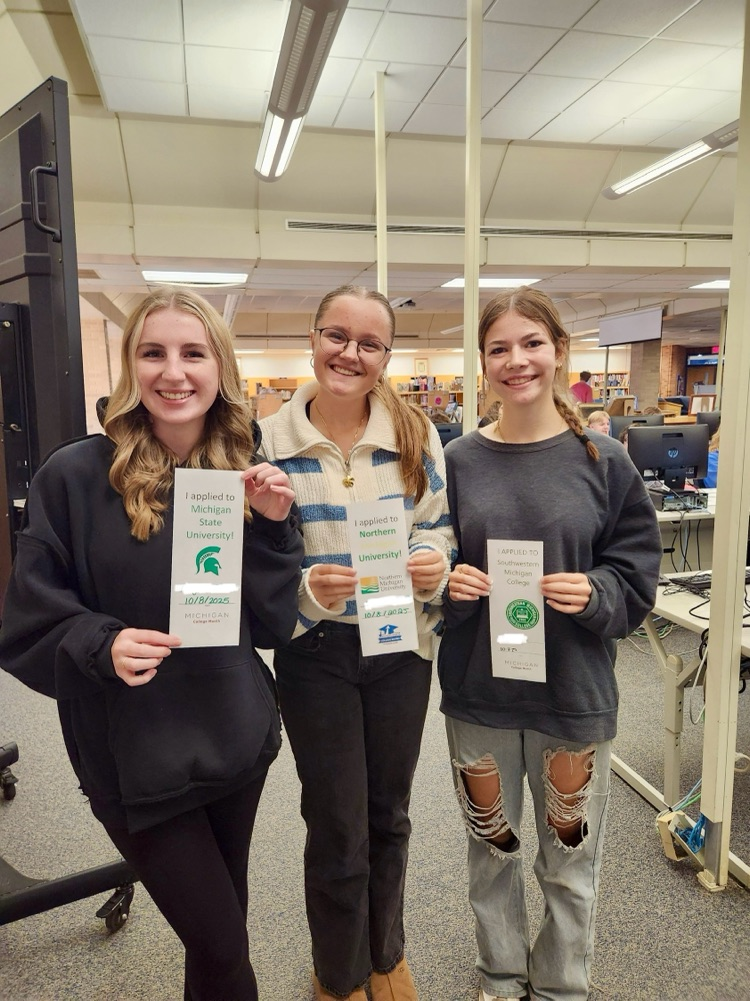 picture of the phs students holding college application signs