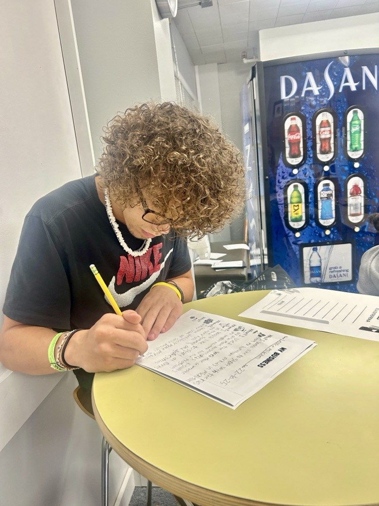 picture of RHS student writing a paper