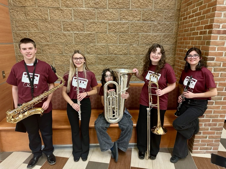 picture of five middle school band students with their instruments 