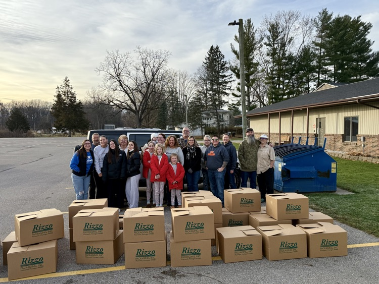 picture of group of staff and community members working a food drive 