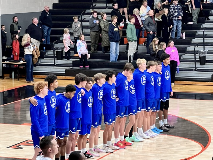 picture of varsity basketball team standing in a line