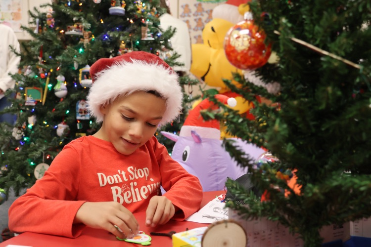 picture of student working on a holiday craft project 