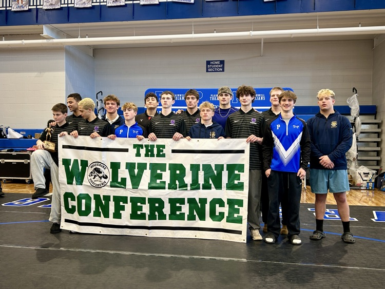 picture of phs boys wrestling team in front of Wolverine conference banner 