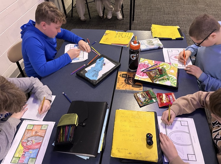 picture of middle school social studies working on a project in class