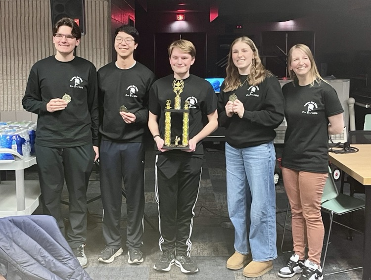 picture of five phs quiz bowl teammates with a trophy  
