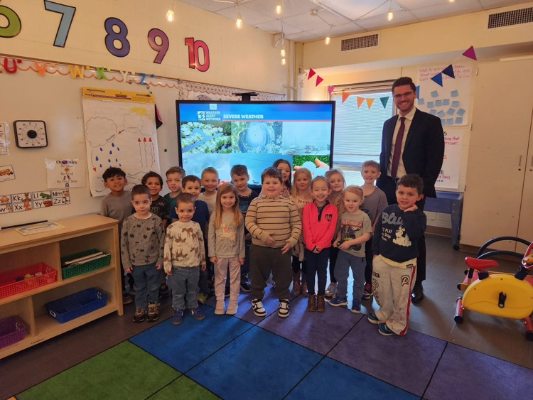 picture of pre-k students with Collin Rogers from WWMT