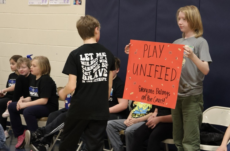 picture of student and staff at their unified champions basketball game 