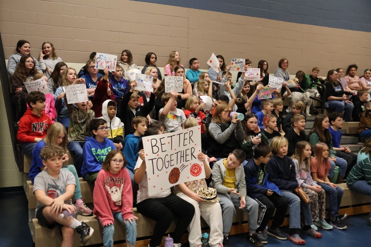 picture of student and staff at their unified champions basketball game 