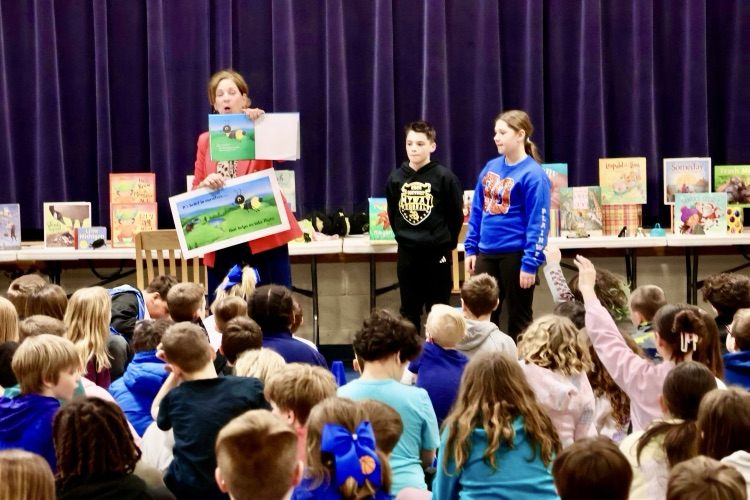 author presenting at Starr elementary with students listening 