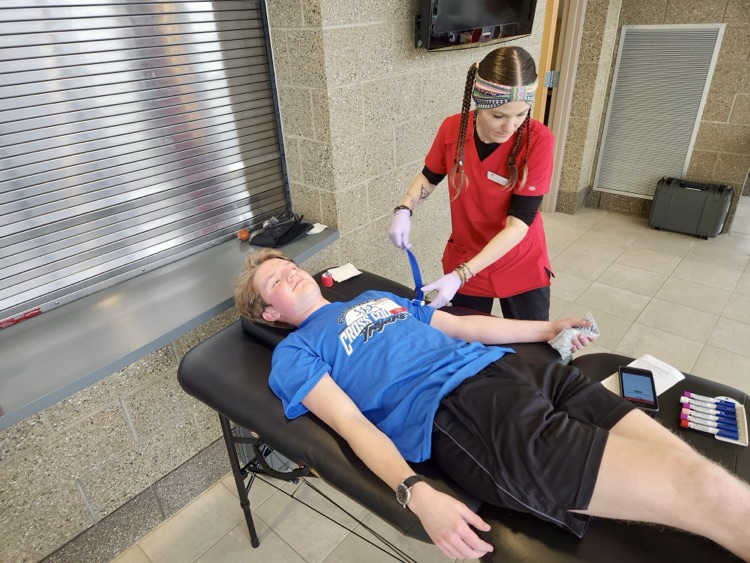 picture of student and Red Cross employee at a blood drive 