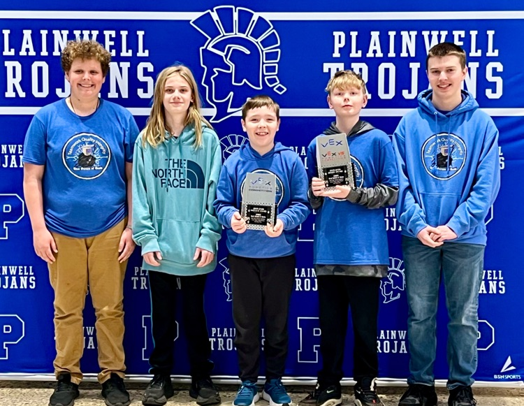 five middle school robotics students holding trophies from state competition 
