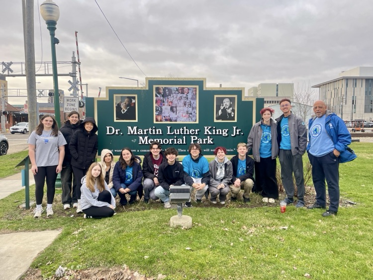 group of phs multicultural students during a day of service in front of the Dr. Martin Lutheran King Jr. memorial park sign
