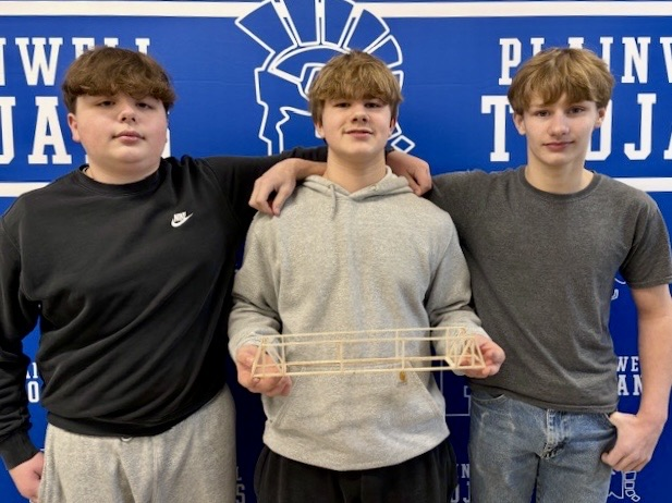 three students with their truss bridge 