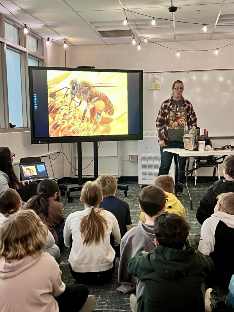 class sitting in a presentation about bees 