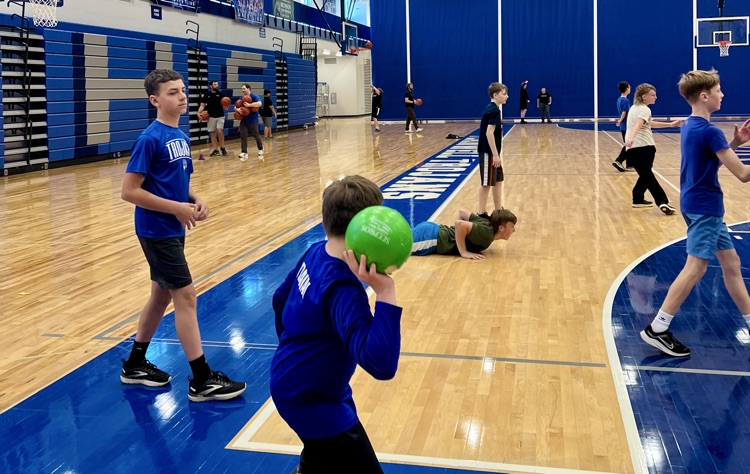 picture of group of students playing dodgeball in the field house 