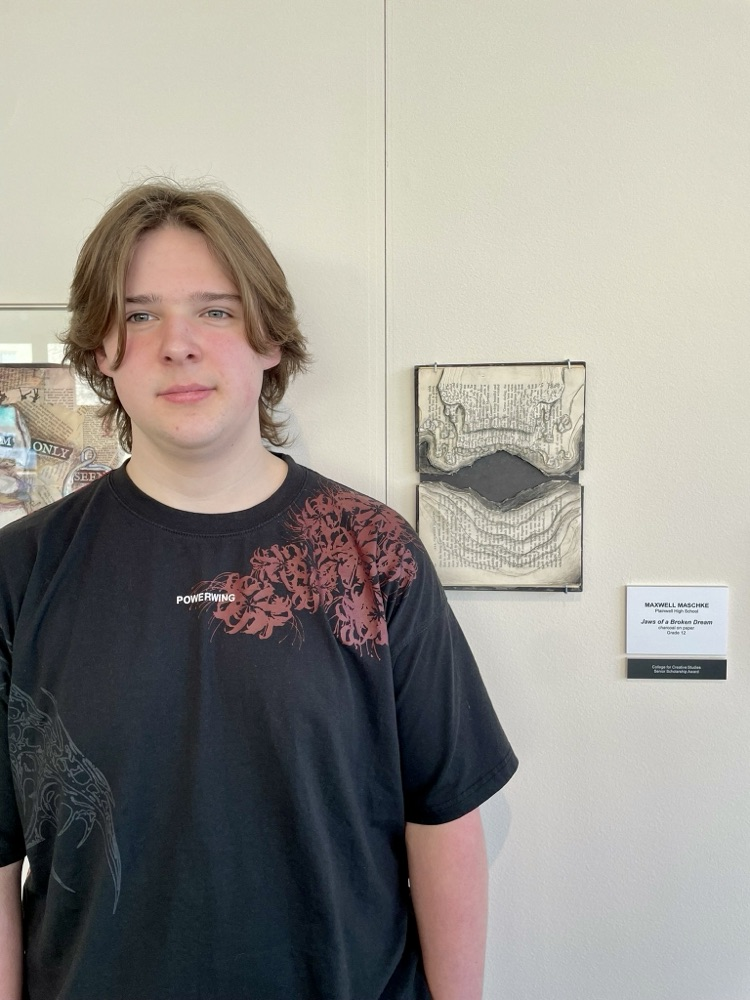 picture of phs artist with their displayed piece at the KIA art show 