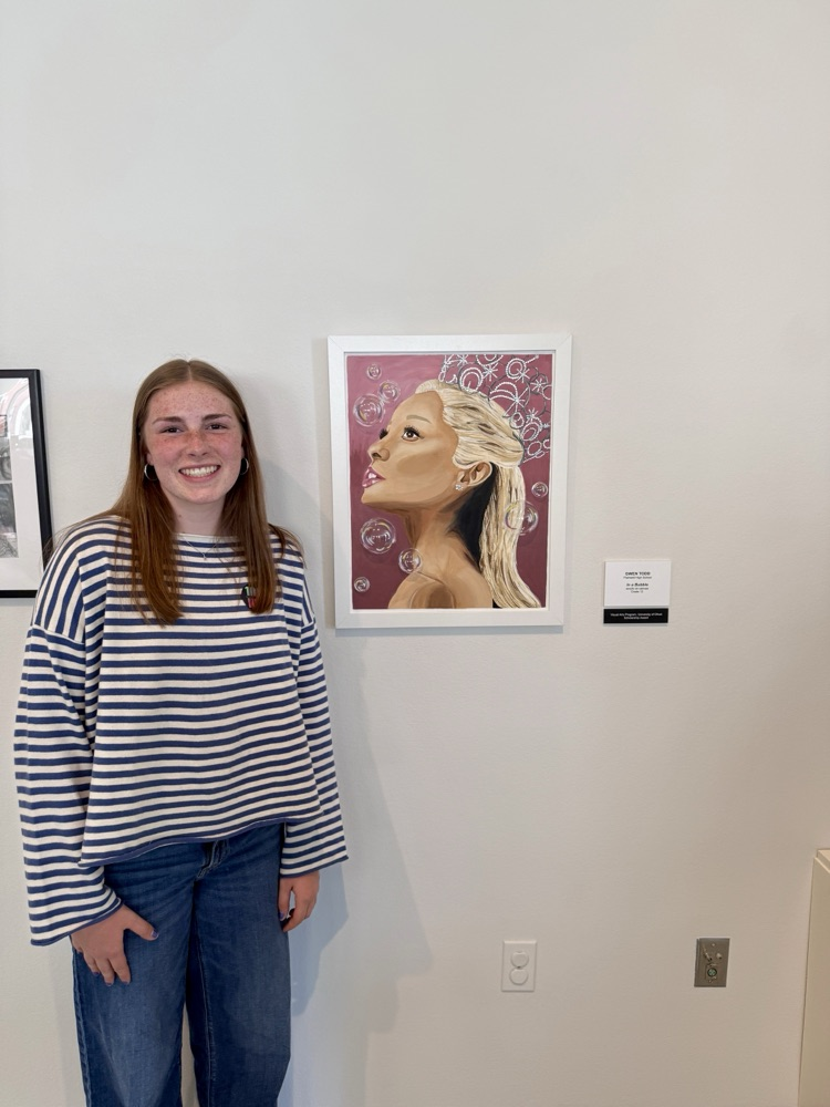 picture of phs artist with their displayed piece at the KIA art show 