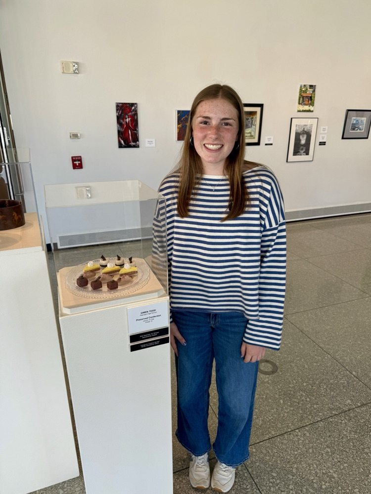 picture of phs artist with their displayed piece at the KIA art show 