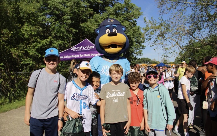 picture of six students at a growlers baseball game with their mascot