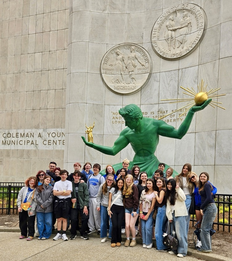 group picture of phs multicultural club in front of a statue in downtown Detroit 