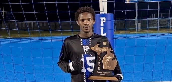picture of phs soccer player holding a trophy 