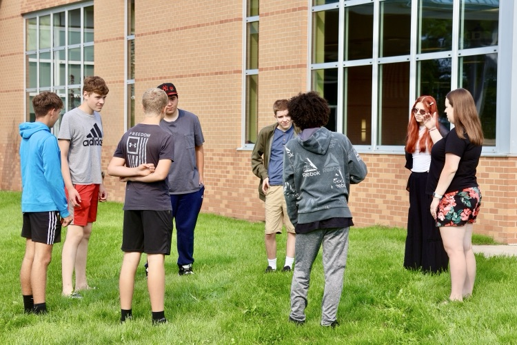 picture of group of students doing an outdoor team building activity during the phs champions program