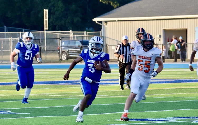football player running towards the end zone in a game