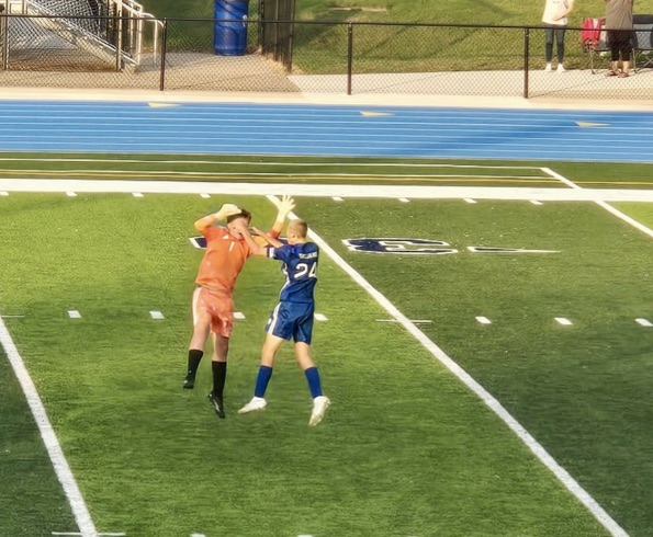 picture of two soccer players giving a high five